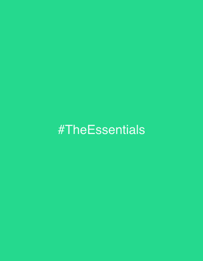 The image, located in Caminha, Portugal, presents a uniform, solid field of vibrant green. Centrally positioned within this green field is the white text '#TheEssentials' rendered in a sans-serif typeface. No discernible people, subjects, objects, actions, interactions, or specific environmental features are depicted. The composition is entirely graphical.