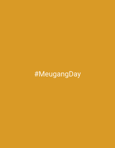 The image is a solid mustard yellow background with the hashtag "#MeugangDay" in white font centered horizontally and vertically. There are no other objects or subjects in the image. The location is not discernible from the image.