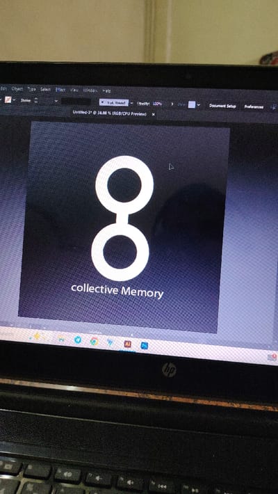 A laptop screen displays Adobe Illustrator. The program is open to a document titled "Untitled-3* @ 38.88% (RGB/CPU Preview)." The design in focus is a stylized logo featuring two stacked white circles connected by a thin line, resembling the number eight. Beneath the logo, the text "collective Memory" is written. The program menus such as "Edit," "Object," "Type," "Select," "Effect," "View," "Window," and "Help" are visible at the top. The taskbar is visible at the bottom of the screen.