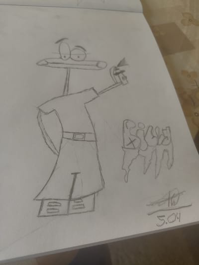 A pencil sketch on a white paper surface depicts a cartoon figure holding an object resembling a flashlight or hammer. The figure has a large head with elongated features, suggesting a humorous or caricature style. The figure is wearing a belt and a long coat or dress. Above and to the right of the figure, there's a word written in stylized letters. The date "5.04" is written along the edge of the page.
The sketch appears to be contained within a notebook or sketchbook. The surrounding environment is out of focus. There is no indication of Nova Zagora, Bulgaria, or any city in the image. There are no other visible people, subjects, objects, actions, or interactions present in the frame.