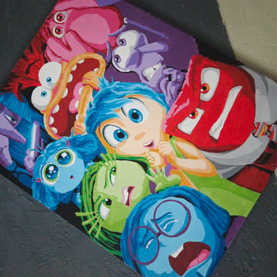 This is a painting of characters from the Pixar movie "Inside Out". The characters depicted are Joy, Sadness, Anger, Disgust, and Fear, all with their characteristic colorful appearances and exaggerated expressions. They are arranged in a chaotic, overlapping composition, suggesting a dynamic or intense emotional state. The background is a dark, textured surface, possibly a wall or a canvas with a similar finish. The overall style is illustrative and vibrant, with bold colors and simplified forms. The characters are the sole subjects, and no specific activity or event is clearly taking place beyond their portrayal. The emotions conveyed are a mix of the characters' inherent feelings: Joy's wide-eyed excitement, Sadness's melancholic blue hue and downturned expression, Anger's fiery red intensity, Disgust's green, skeptical look, and Fear's purple, wide-mouthed alarm. The image does not contain any visible text. The location context of Vyshgorodok, Russia, is not visually indicated in the painting itself.