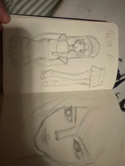 This media file is a sketch of two figures. On the left, a full-body sketch of a young woman is depicted. She is wearing a beret, a dress with a flared skirt, and knee-high socks with a polka dot pattern. The dress also appears to have a polka dot pattern. She has long, straight hair that falls past her shoulders and her eyes are closed, giving her a serene or perhaps melancholic expression.

To the right of the full-body sketch, there is a detailed drawing of her legs and feet, showcasing the polka dot pattern on her socks and elegant, heeled shoes.

On the right side of the sketchbook page, a large, close-up sketch of a person's face is drawn. This face has long, flowing hair that frames the face and a prominent, almond-shaped eye. The gaze is directed forward with a sense of intensity or contemplation. The lower half of the face is also sketched, revealing lips and a chin. The overall style of both sketches is loose and expressive, rendered in pencil.

Visible text above the full-body sketch reads "Polka Girl". The background of the image suggests the sketch is in a notebook or journal, with a striped fabric visible on the left side. The lighting in the image is dim, suggesting an indoor setting, possibly at night. The emotional tone of the sketches is somewhat somber or introspective.