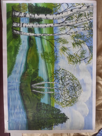 The image is a painting of a serene natural landscape, featuring a river flowing through a green, tree-lined area. The painting is oriented vertically, with the river and its reflection occupying the left half and the sky with clouds and trees on the right. Several birch trees with their characteristic white bark and dark markings are prominently depicted. Some branches of these trees extend across the canvas, adorned with green leaves. The river's surface reflects the surrounding greenery and the blue sky with white clouds. The overall impression is one of a peaceful, possibly rural setting. The provided image does not contain any information or context related to the city of Kipshek, Russia, or any specific urban location.