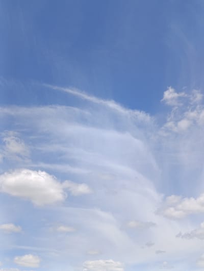 The image displays a bright blue sky with scattered white clouds. The clouds vary in density, with some appearing wispy and thin, while others are more substantial and puffy. The overall lighting suggests it is daytime. The photograph is taken from a low angle looking upwards. There is no indication of the city of Samar, Ukraine, or any specific geographical features or urban elements within the frame. The scene is purely natural, focusing on the sky and cloud formations.