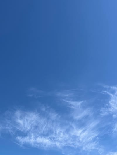 The image is a photograph of a bright blue sky with wispy white cirrus clouds scattered across the lower portion. The clouds are thin and feathery, suggesting high altitude and fair weather. The sky occupies most of the frame, with the clouds concentrated towards the horizon. The scene appears to be an outdoor environment, likely taken during daylight hours. No specific landmarks or geographical features are visible that would pinpoint the location to Ikryanoye, Russia. The image focuses solely on the sky and clouds.