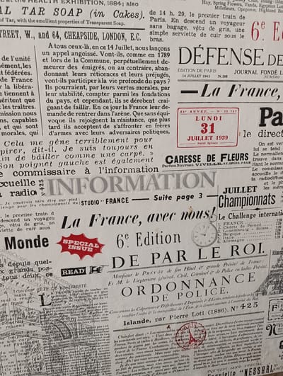 This is a grayscale, close-up, horizontal photograph of a collage of newspaper clippings and advertisements, likely from the early 20th century. The primary subjects are text and typography, arranged in a dense, layered manner. There are no discernible people, objects, or clear scene setting beyond the printed materials themselves.
The activity taking place is implied through the content of the newspapers, which include headlines like "DÉFENSE DE LA FRANCE," "La France, avec nous!", and "ORDONNANCE DE POLICE." This suggests a context of news reporting, political commentary, and official decrees. The "SPECIAL ISSUE" stamp on one clipping further indicates a significant event or publication. Advertisements for "TAR SOAP" and "CARESSE DE FLEURS" are also visible.
Notable details include the various fonts and sizes of text, ranging from large, bold headlines to smaller, dense paragraphs. Some clippings have faded or torn edges, adding to the vintage feel. The text spans multiple languages, including French and English. The overall impression is one of historical documentation and layered information, possibly representing a historical archive or a collection of ephemera. There are no clear indicators of time of day, weather, or location beyond what can be inferred from the printed content itself. The emotions conveyed are neutral, inherent in the presentation of printed matter.