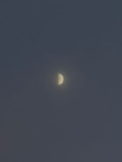 The image depicts a clear night sky with a crescent moon. The moon is partially illuminated, showing its shape against the dark blue of the sky. There are no visible artificial lights or structures. The scene is devoid of any signs of human presence or activity. The image does not contain any information that would allow for the identification of a specific location, including Hausach, Germany.
