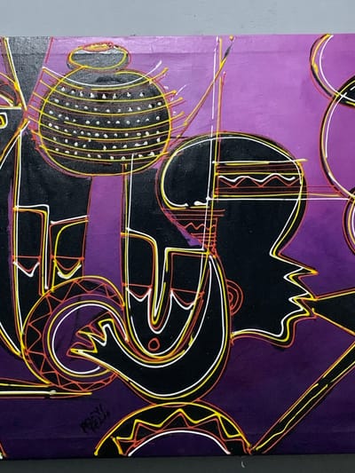 The image is a painting with a purple background. Black figures with yellow, white, and orange outlines dominate the scene. The figures appear abstract, possibly depicting people and musical instruments. One figure has a jagged, crown-like shape. Another has a circular shape, covered in dots, resembling a beaded instrument. The painting includes concentric circles. There is writing in the bottom right corner. There is no indication of its location in Ibasa, Nigeria.
