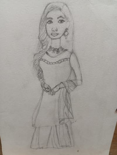 A pencil sketch on textured paper depicts a young woman standing. She has long, wavy hair, a rounded face with large eyes and full lips, and is wearing an ornate necklace and a dangling earring. Her hands are clasped together in front of her. She is dressed in a traditional or formal outfit, with a flowing top and a tiered skirt. The background is plain and undetailed, suggesting an indoor setting or a studio portrait. The sketch is in black and white, with varying shades of gray from the pencil shading. There is no indication of any specific location in the city of Seýdi, Turkmenistan.
