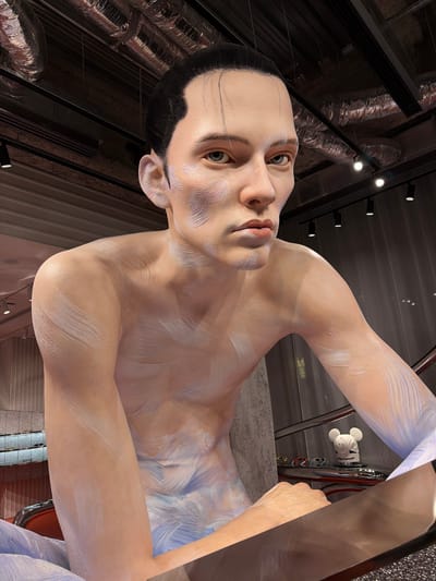 This is a close-up, low-angle, full-body shot of a hyperrealistic, life-sized statue of a person, possibly a male, with pale skin and dark hair slicked back. The statue is positioned in what appears to be a retail or exhibition space with a darkly lit ceiling featuring exposed industrial ductwork and spotlights. The statue is partially covered in white and blue paint or plaster applied in brushstroke-like patterns, accentuating the musculature of its torso and arms. The statue is seated or leaning forward, with its arms positioned in front of it, resting on a reflective surface. In the background, a display shelf is visible with a small white figurine resembling a mouse wearing a hat that says "little monster" and three pairs of sunglasses. The environment suggests an indoor location, possibly a store or gallery in Chuo, Japan, given the context provided, though the image itself does not contain overt geographical markers for Chuo, Japan.