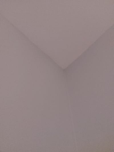 The image shows a corner of a room with pale, off-white walls. There are no visible objects or people present. The image was taken at a location in Pitt Meadows, British Columbia, Canada with coordinates of latitude 49.2, longitude -122.678.