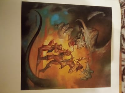 The image depicts a surreal, action-packed scene, possibly an illustration for a fantasy novel or game. The central focus is on a battle between two human-like figures and a large, monstrous creature. The figures, one male and one female, are depicted in dynamic poses, engaged in combat. The male figure, with muscular build and wearing a loincloth and boots, is shown lunging forward, wielding a sword. The female figure, similarly scantily clad, is falling or being lifted by the monster. The monster is a grotesque, reptilian or dragon-like entity with sharp claws, teeth, and horns. The background is a chaotic blend of fiery oranges, smoky blacks, and hints of ethereal blues and greens, suggesting a hellish or otherworldly landscape.

The image is presented on a page with a white border, and the page itself is set against a background that appears to be a patterned fabric, possibly a tapestry or rug, with a red and brown motif. The lighting in the image suggests an internal light source or the glow of fire, casting dramatic shadows and highlights on the figures and the monster.

The question about the location in the city of Zhmerynka, Ukraine, cannot be answered based on the provided image. There are no identifiable landmarks, architectural features, or any contextual clues within the image that would associate it with Zhmerynka or any specific geographical location. The image is purely a fictional, artistic depiction.