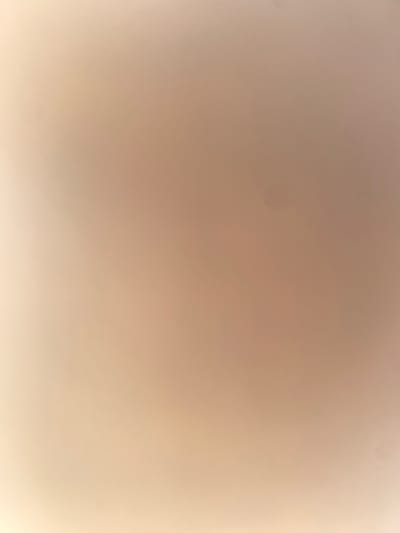 The image is an abstract shot of a smooth, light-colored surface with subtle variations in tone and illumination. The surface appears to be uniformly textured, with no discernible objects or features. The lighting creates a soft gradient, with a brighter area on the lower left and a darker, more uniform tone across the rest of the image. There are no people, animals, or any other living subjects present. The overall impression is one of simplicity and minimalism, with the focus on the texture and light of the surface. There is no indication of a specific location within the city of Ablanitsa, Bulgaria, or any environmental context that would place it there.