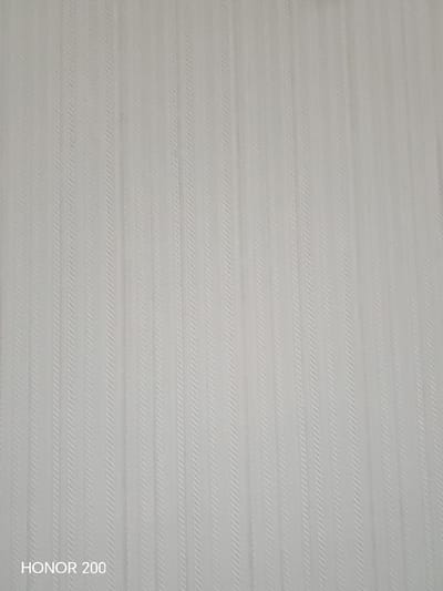 The image shows a close-up of a textured, off-white surface. The texture is made up of vertical, raised lines that appear to be woven or embossed in a subtle herringbone pattern. There is text in the lower left corner that reads "HONOR 200". The image does not contain any information about the city of Aksu, Kazakhstan.