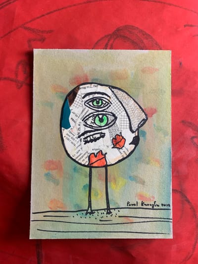 A watercolor and collage artwork depicts a stylized, abstract face with three green eyes and red lips, standing on two thin legs. The face is composed of torn paper fragments, including text and a grid pattern, with a blue and brown tear on the left side. The background of the artwork is a light green with splashes of yellow, orange, and blue watercolor. The artwork is signed "Pavel Karaglu 2015" in the bottom right corner and is placed on a red surface with visible charcoal or pencil markings. The location of Sergeevo, Russia is not discernible from the image.