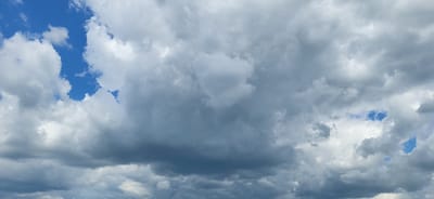 This is a photograph of a cloudy sky taken from Tetianivka, Ukraine. The image is dominated by large, grey, and white clouds, with small patches of blue sky visible in between. The clouds are varied in texture and density, suggesting a dynamic weather system. The overall impression is of an overcast day with the potential for rain. There are no people, subjects, or specific objects visible that would indicate a particular activity or event. The scene is purely environmental, capturing a moment of the sky's natural state.