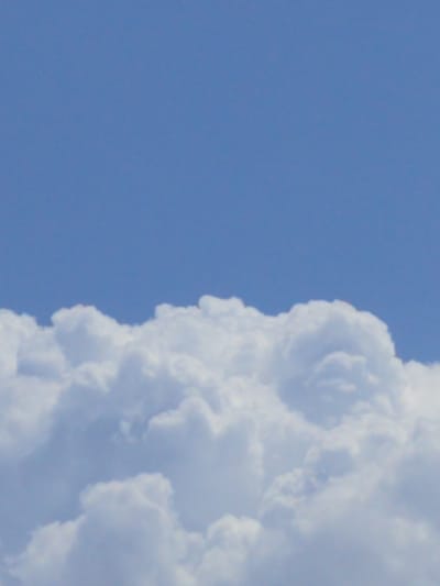 The image is a photograph of a blue sky with cumulus clouds. The clouds are white and puffy, and they are situated in the lower half of the image. The sky is a clear blue. There are no people, structures, or geographical features visible in the image that would indicate its location in Balkanabat City, Turkmenistan.