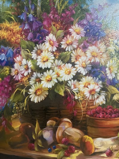 This is a close-up, detailed oil painting of a still life arrangement. The foreground features a wooden surface displaying several ripe raspberries, two blueberries, what appear to be loaves of bread, and a peeled peach. Behind these items, a rustic wooden bowl overflows with more raspberries.
The background is dominated by a lush, abundant bouquet of vibrant flowers. White daisies with yellow centers are prominent, interspersed with blue and purple bell-shaped flowers, as well as clusters of smaller yellow and pink blossoms. Green foliage adds depth to the floral arrangement. The overall impression is one of rich, natural abundance, likely depicting a scene in a rural setting, though no specific urban features are visible to indicate a location within the city of Аргамак, Russia.