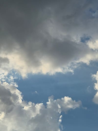This is a photograph of a sky filled with clouds. The sky is blue, and there are white and gray clouds scattered throughout. The clouds are fluffy and appear to be moving. The photograph appears to be taken from a low angle, looking up at the sky. There are no people or objects visible in the photograph. The time of day appears to be daytime, and the weather appears to be partly cloudy. The location cues are not specific enough to determine the exact location, but it is implied to be Lenina, Russia. There is no text visible in the photograph.