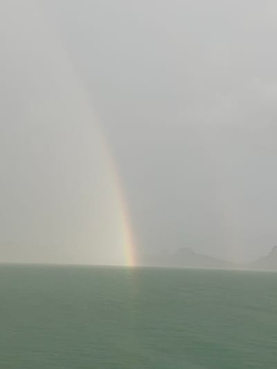 The media file depicts a close-up, abstract view of a light source creating a subtle rainbow effect against a textured, muted background. The primary subject appears to be a prismatic light phenomenon, with faint bands of color, including yellow, orange, and a hint of purple, visible on the left side of the frame. This light is casting onto a pale, textured surface that transitions to a darker, greenish-grey textured surface on the right.
The texture of the surfaces is pronounced, suggesting materials like stucco or rough-painted walls. The lighting suggests a bright, possibly diffused light source, hinting at daylight. The scene is devoid of any human figures, animals, or recognizable objects. The overall impression is one of subtle atmospheric conditions or an interaction of light with a surface.
The location context of Don Sak, Thailand, combined with the visual elements, might suggest a scene involving sunlight reflecting or refracting through moisture in the air, perhaps near water or after a rain shower, illuminating a building's exterior. The time of day is likely daytime due to the bright light, and the weather conditions are suggested to be conducive to light refraction. There is no visible text in the media file.