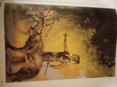 The image depicts a dramatic scene featuring a wolf and two humans against a backdrop of a forest with a bright, yellowish sky. A large wolf is on the left, facing right with its mouth open. To the right of the wolf is a man with fair skin, wearing a green garment and a necklace, reaching out with both hands. In the background, another man, also fair-skinned and wearing a green garment, is falling backward. In the foreground, to the right, stands a muscular man with dark hair, adorned with ornate jewelry around his neck and waist. He is holding a stick in his right hand and raising his left hand with his index finger extended. The overall mood is intense and action-oriented. The image is a painting, likely an illustration for a fantasy or historical narrative. There is no visible information in the image that would indicate its location in Zhmerynka, Ukraine.