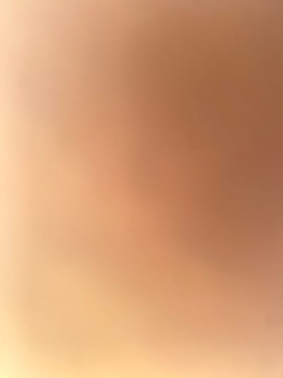 The image displays a blurry, abstract background with a gradient of warm, peachy-orange tones. There are no discernible objects, people, or environmental features visible. The lighting appears soft and diffused, creating a smooth, almost ethereal texture across the entire frame. The image is not suitable for providing details about the city of Ablanitsa, Bulgaria, as it contains no specific information related to that location.