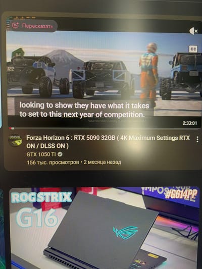 The image is a screenshot of a video player interface. The video content appears to be a gameplay or a simulation featuring off-road vehicles in a desert-like environment with mountains in the background. Text overlays on the video indicate "looking to show they have what it takes to set to this next year of competition." Below the video player, information about a video titled "Forza Horizon 6 : RTX 5090 32GB (4K Maximum Settings RTX ON / DLSS ON ) GTX 1050 Ti" is displayed, along with view count and upload date. Another section of the screen shows an advertisement or preview for "ROG STRIX G16". There are no elements in the image that indicate a location in Mirnoye, Ukraine.
