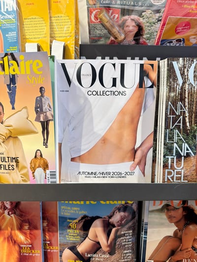 This photograph shows a display of magazines. Prominently featured are several copies of "Vogue Collections" Autumn/Winter 2026-2027 edition, stacked next to "Claire Style" and a magazine with "Naturale" printed on the cover. Also present are "Gala & Rituals", "Beauté" and "LEA DRUCKER" magazines.
The context suggests this image was taken in Le Mesnil-Amelot, France, inferred from the "Vogue France" edition and likely location of items.