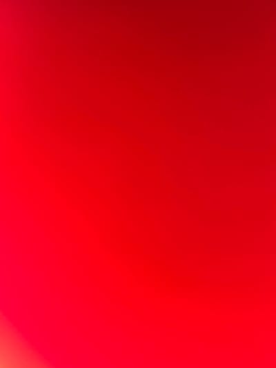 The image is a solid, vibrant red color with some slight gradient variation in brightness. There is no indication of the city of Sabo, Nigeria or any other elements typically associated with forensic scene descriptions.