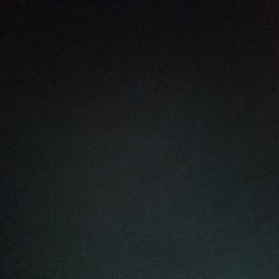 The image is an underexposed, dark photograph. The environment is not discernible, and it is impossible to identify any people, subjects, objects, actions, or interactions. The location of Satellite Town, Nigeria, is not evident from the visual information.