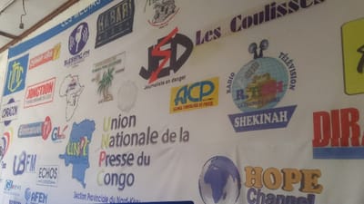 The image displays a banner featuring logos of various media outlets and organizations. There are radio stations like Blessing FM, Habari, and Shekinah, along with TV channels such as R.T.H. La Chaine de Globe. Organizations like Union Nationale de la Presse du Congo and ACP (Agence Congolaise de Presse) are also represented. Additionally, there are logos for online news platforms like Gl.news and community broadcasters like Junction. "Journaliste en Danger" is another organization displayed, along with Hope Channel.