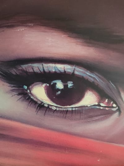 The image is a close-up, highly detailed painting of a human eye. The artwork focuses on the iris, pupil, eyelashes, and surrounding skin. The eye appears to be a rich, deep purple or dark burgundy, with lighter tones and highlights on the sclera and within the iris. Eyelashes are dark and defined, framing the eye. The skin around the eye is rendered in shades of pink and red, with subtle variations in tone and texture suggesting soft skin. The lighting in the painting creates a dramatic effect, with strong reflections visible in the pupil and on the surface of the eye. There is no indication of any specific location in Soisy-sous-Montmorency, France, or any broader environmental context. The focus is entirely on the artistic representation of the eye.