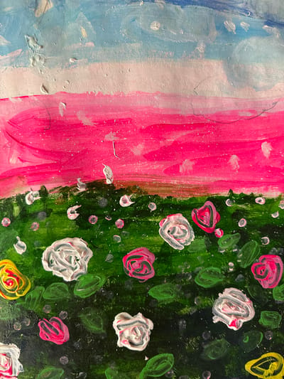 The image appears to be a close-up of an abstract painting. The left third of the painting is a vertical arrangement of blue, white, and pink paint, with visible brushstrokes. The right two-thirds of the painting depicts a floral pattern against a dark green background. The flowers are painted in various colors including white, pink, and yellow. Small green leaf-like shapes and white dots are scattered throughout the green background. There is no indication of the city of Mèo Vạc Commune, Vietnam in the image.