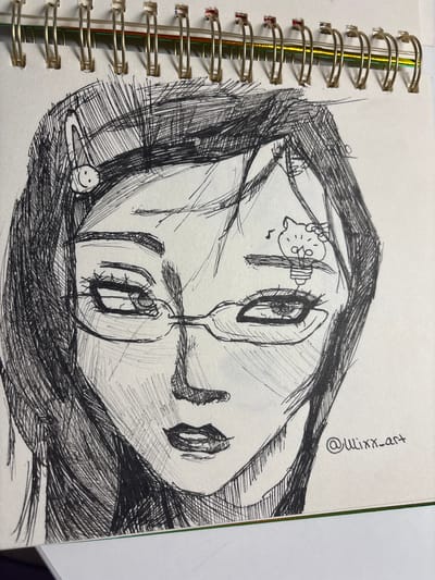The image is a close-up, black and white ink drawing on paper, depicting the upper torso and head of a person wearing glasses. The drawing style is sketch-like, with heavy use of cross-hatching for shading. The person's eyes are looking slightly to the side, and their lips are partially open. There are two small cartoonish elements drawn on the person's forehead: a smiley face clip on the left side and a stylized lightbulb with a cat-like figure on top on the right side. A signature, "@wilxx_art", is visible in the bottom right corner of the drawing. The drawing is part of a spiral-bound notebook, with the metal spiral visible at the top edge of the image. The background is a plain white surface. There is no indication of the city of Velbert, Germany, or any specific urban environment within the image.