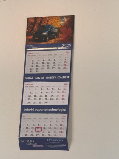 The image displays a wall calendar for the year 2026. It features a promotional picture of a dark blue van with "SYSTEMY okienne" branding. Below the image are calendars for March, April, and May. Each month's calendar includes days of the week in Polish: "TYDZIEŃ", "PONIEDZIAŁEK", "WTOREK", "ŚRODA", "CZWARTEK", "PIĄTEK", and "SOBOTA" followed by "NIEDZIELA". The calendar also shows the company name "SYSTEMY okienne", the name "Piotr Siwak", a phone number "512 845 964", and company address details.