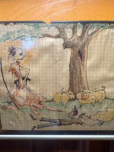 This is a drawing on grid paper depicting a surreal scene with stylized figures. On the left, a tall, thin figure with a pink bow in its hair wears a flowing orange and red garment. It holds a long, black object, possibly a sword, in its left hand and rests its right hand on its hip. To the right of this figure, a large, bare tree with dark branches dominates the center of the composition. At the base of the tree, three yellow, pig-like creatures with large smiles are gathered. In the foreground, a prone male figure in a checkered shirt and blue pants lies on the ground, reaching towards one of the pig-like creatures with a bottle in its other hand. The background shows a light blue, wavy pattern suggesting water or sky. The scene appears to be an outdoor setting. There is no indication of the city of Naro-Fominsk, Russia within the image or its context.