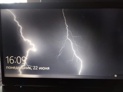 The image displays a laptop screen showing a lock screen with a lightning strike on a dark background. The time displayed is 16:09, and the date reads "понедельник, 22 июня" (Monday, June 22nd). The image does not provide any information about the city of Chita, Russia. There are no people or specific objects visible other than the laptop screen itself. The environment depicted is a stormy sky with a prominent lightning bolt.