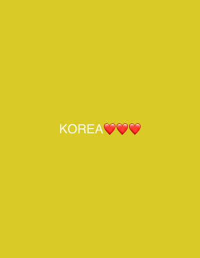 The image shows the word "KOREA" written in white text, followed by three red heart emojis. The background is a solid yellow color. The text and emojis are centered horizontally in the frame and positioned towards the bottom. There are no people, buildings, or any other objects present in the image. The image is a simple graphic with text and emojis on a plain background. No specific location in Gyeongju-si, South Korea is depicted.