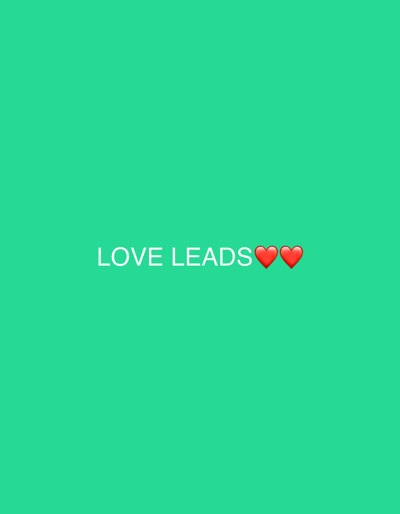 A light green background features the white text "LOVE LEADS" centered. Two red heart emojis follow the words, spaced closely together. The text and hearts are positioned near the middle of the image. The overall impression is simple and positive, conveying a message about the power of love.