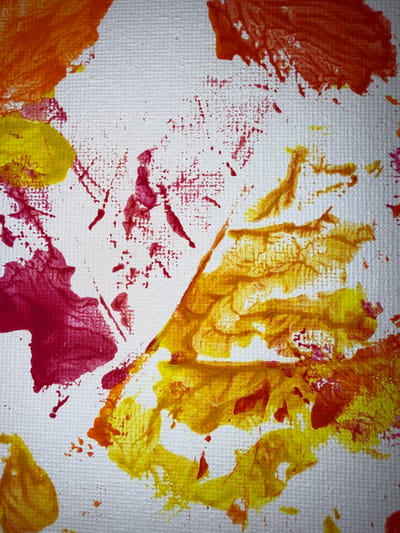 The image displays an abstract painting with bold strokes of red, yellow, and orange on a white canvas. The textured surface of the canvas is visible through the paint. The paint application is varied, with some areas showing thick, opaque layers and others displaying thinner, translucent washes. There are splatters and drips of paint, adding to the dynamic and energetic feel of the composition. Some areas of paint appear to have been applied with a brush or a similar tool, creating distinct strokes, while others suggest dabbing or stamping techniques. The colors are vibrant and create a sense of warmth and intensity. The painting does not depict any recognizable objects or scenes and appears to be purely an exercise in color and form. The provided information about the location in Ridabu, Norway, is irrelevant to the visual content of the image.