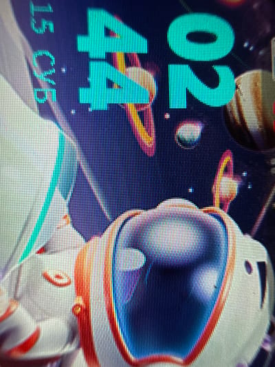 The image shows a screen displaying a digital clock set to 02:44 and the date "15 СУБ". An astronaut illustration is also visible on the screen, alongside depictions of planets and celestial bodies. There is no information available to suggest this is in the city of Kosh, Armenia.
