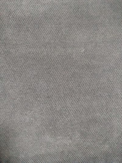 The image displays a close-up, textured view of dark grey fabric. The fabric has a diagonal weave pattern, characteristic of denim or a similar twill weave. There are no people, objects, actions, or environmental details visible. The image does not depict any location in Sabunchu, Azerbaijan, or any other specific geographic area. It is a purely textural image of a material.