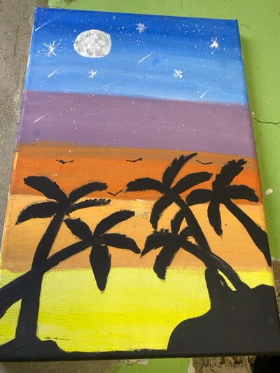 The subject is a rectangular canvas painting depicting a stylized tropical night scene, located in the city of Chimbote, Peru. The painting's sky is divided into horizontal color bands: deep blue at the top, transitioning through purple, then to orange at the horizon. A textured white full moon is positioned in the upper-left of the blue sky, surrounded by numerous small white stars and several white streaks indicating shooting stars. Multiple small black bird silhouettes are visible within the orange sky band. The lower section of the painting features a bright yellow field, likely representing a beach or sand. This yellow area is bordered by black silhouettes of landmasses and five prominent palm trees with black trunks and fronds. Two palm trees are on the left, extending from the bottom edge, while three are on the right, partially integrated with an undulating black landform in the bottom-right corner. The painting displays a visible brushstroke texture and minor surface imperfections. The canvas rests on a mottled gray concrete surface, with a section of bright green, cracked paint visible to its right. No individuals or active subjects are present in the immediate environment surrounding the painting.