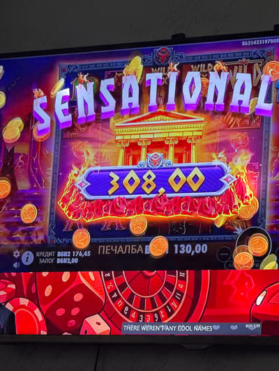 This is a photograph of a digital display showing a casino game. The game appears to be a slot machine with a Greek or Roman theme, indicated by the architectural elements and flaming effects. The word "SENSATIONAL" is displayed prominently. The numerical value "308.00" is shown, possibly representing a win amount. Other text includes "ПЕЧАЛБА B 130,00," likely indicating a payout of 130.00 in some currency. The phrase "THERE WEREN'T ANY COOL NAMES" is also visible. Currency indications include "BGN2 176,45" and "BGN2,00." The image also contains a roulette wheel and dice elements. There is no mention of Glojene, Bulgaria.