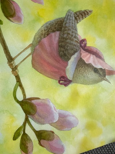 A watercolor painting depicts a small bird wearing a pink bonnet and dress, perched on a branch with pink flower buds. The bird's back is facing the viewer, with its head turned to the right, revealing its profile. The background is a wash of yellow and green watercolor. The painting is not located in Ridabu, Norway.
