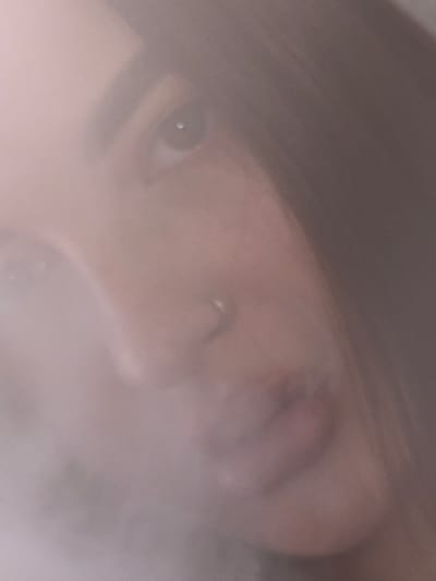 The image shows a close-up of a person's face obscured by a hazy or smoky effect. An eye is visible on the left side of the frame, along with a nose and a partial view of the mouth. The upper portion of the head is covered by dark hair. The location of Tliustenkhabl', Russia, is not determinable from the visual information provided.