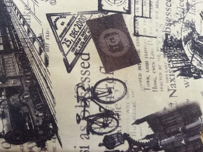The image displays a vintage-style collage of various graphic elements, including what appears to be a passport stamp with the date "25, DEC 2000," a bicycle, a train car, and text in a font that suggests old documents or postcards. The overall impression is of a travel or historical theme, with a black and white, textured aesthetic. The location in Qarabulaq, Kazakhstan, is not represented or suggested in the image.