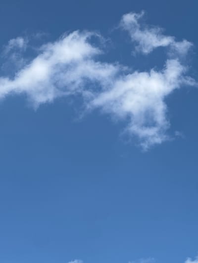 This media file is a photograph of a clear blue sky with scattered white, wispy clouds. The clouds are thin and appear to be cirrus or cumulus clouds. The sky is a bright, vibrant blue, suggesting it is daytime, likely midday or afternoon. There are no people, objects, or man-made structures visible in the frame, only the natural elements of the sky. The image captures a peaceful and serene natural scene. The lighting suggests a sunny day, and there are no indications of inclement weather. The location context of Maladzyechna, Belarus, is not visually evident from the image itself, as it depicts a universal sky scene. There is no visible text in the image.