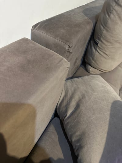 The image shows a close-up of a modular gray sofa. It features large, soft cushions and angular, upholstered bases. The location is not discernible from the image, and there is no information to suggest it is in Rakovski, Bulgaria. There are no people visible in the scene.