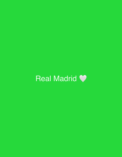 The image displays the text "Real Madrid" in white font, centered horizontally against a vibrant green background. To the right of the text, a white heart emoji is also visible. The setting is a plain, solid green, with no discernible environmental features or location indicators that would suggest a specific city like Safari, Nigeria. There are no people, objects, or actions depicted in the image.